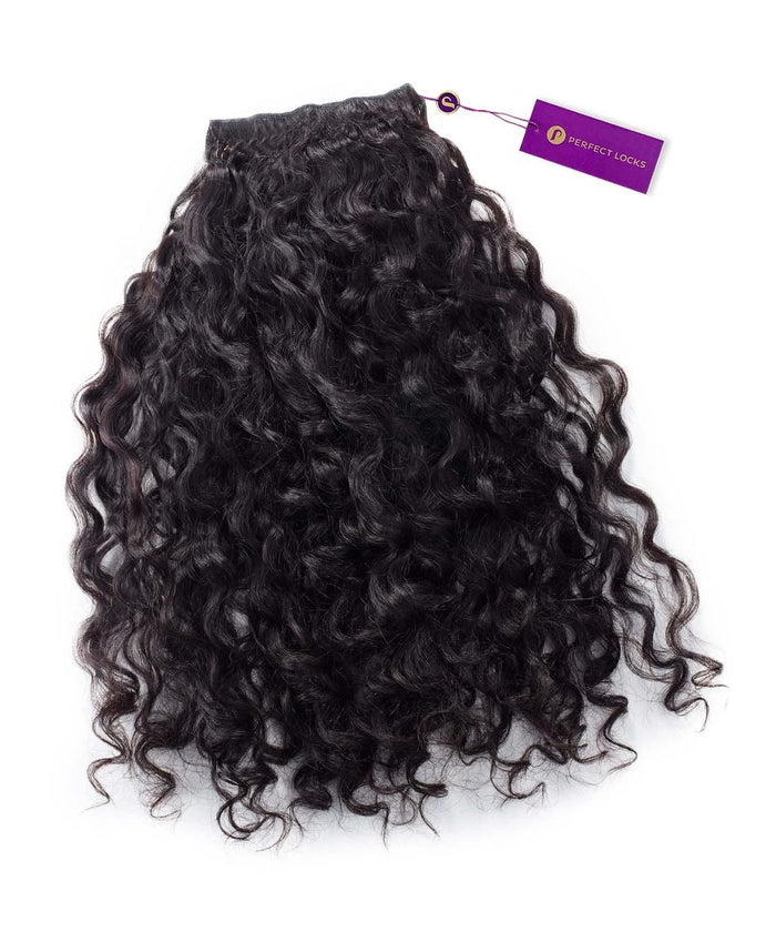 A bundle of Perfect Locks Curly Virgin Hand-Tied Weft extensions in Natural Black  with a purple tag at the top.