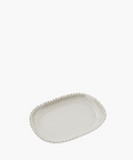 A white rectangular plate with an embossed bead pattern along the edge. The elegant design conveys a classic and sophisticated tone. | SW Home