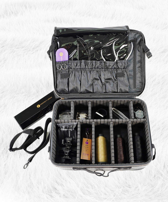A gray organizer bag with detachable strap on a white furry surface holds threads, scissors, and tools; black box beside it.