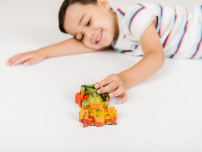 Multi-colored rainbow crayon in the shape of a race car. This fun and functional rainbow crayon by Art 2 the Extreme is perfect for your Indianapolis 500 party ideas and kids birthday gifts.