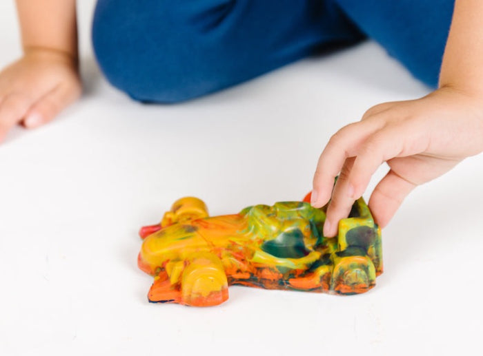 This is a multicolored crayon in the shape of an Indycar race car. It is about as large as an adult hand and is an oversized crayon for kids. This individual crayon is a great race car party favor or gift to pair along with a race car coloring page.