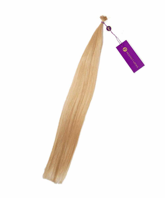 A bundle of Straight Fusion I-Tip Hair by Perfect Locks in Golden Brown , tied at the top with a purple tag attached.#color_honey-blonde-(27)