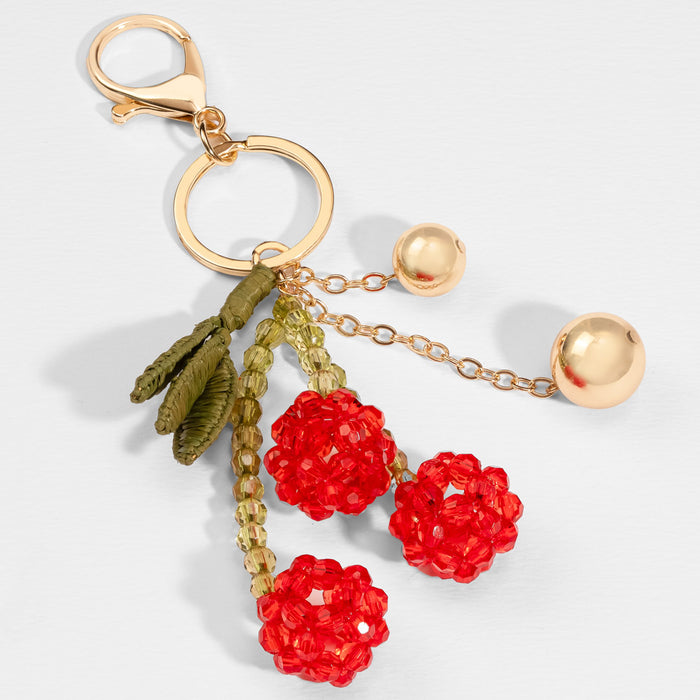 Statement cherry bag accessory with beaded fruit charms, raffia fringe and metal loop clip