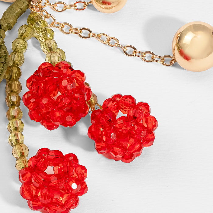 Summer-inspired cherry keychain charm with acrylic beads, raffia details and chain hardware
